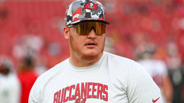 Aug 13, 2022; Tampa, Florida, USA; Tampa Bay Buccaneers center Ryan Jensen (66) looks on from the field during warm ups before a game against the Miami Dolphins during preseason at Raymond James Stadium. Mandatory Credit: Nathan Ray Seebeck-USA TODAY Sports  